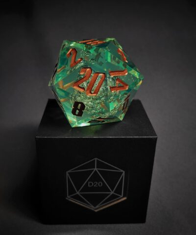 Green transparent dice with bubble inside and golden numbers standing on a black box with "D20" written on it.