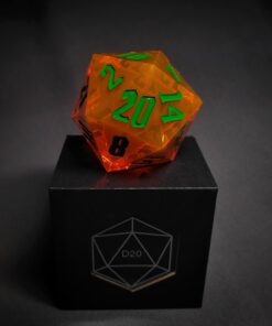 Orange transparent dice with green numbers standing on a black box with 