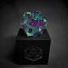 Green Transparent dice with bubbles inside and purple numbers standing on a black box with "D20" written on it.