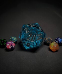 An extra large bright blue transparent d20 die with bubbles and silver numbers sitting in the middle of 6 smaller d20 dice.