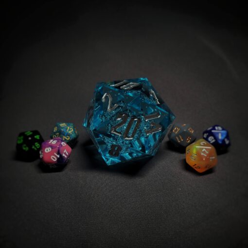 An extra large bright blue transparent d20 die with bubbles and silver numbers sitting in the middle of 6 smaller d20 dice.