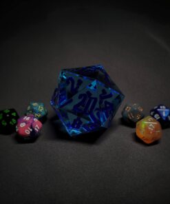 An extra large blue transparent d20 die with dark blue numbers sitting in the middle of 6 smaller d20 dice.