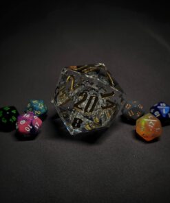 An extra large transparent d20 die with bubbles and golden numbers sitting in the middle of 6 smaller d20 dice.