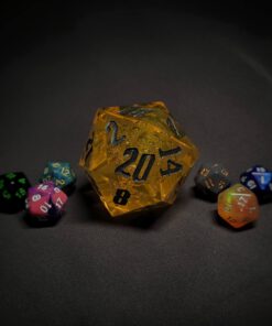 An extra large yellow transparent d20 die with silver numbers sitting in the middle of 6 smaller d20 dice.