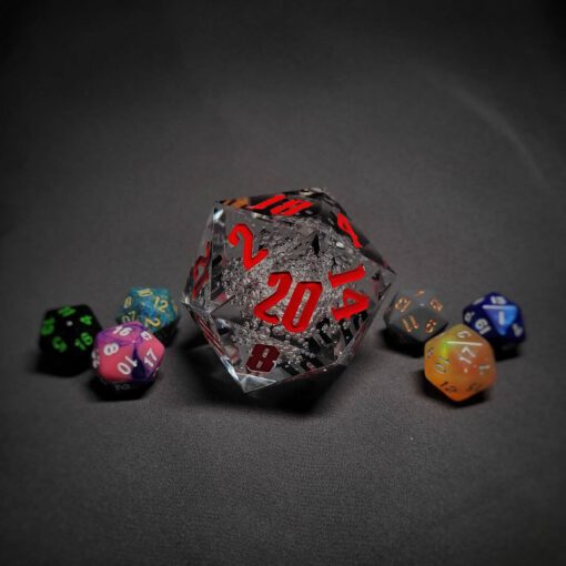An extra large transparent d20 die with red numbers sitting in the middle of 6 smaller d20 dice.